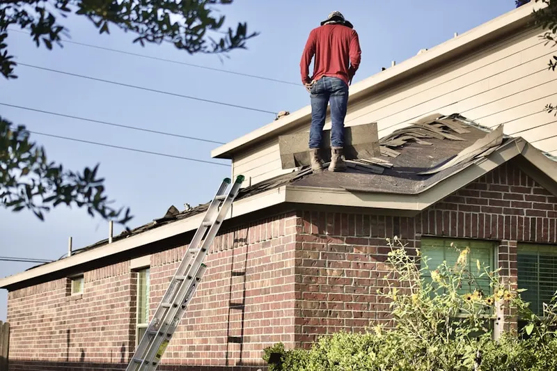 Professional roofer working on a residential roof in American Beauty